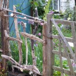 A rustic fence forming a boundary  in the 'Postcard from Wales' Garden