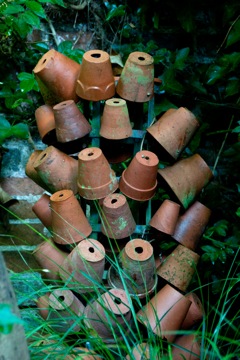 garden pots on an old bottle stand make an interesting garden feature