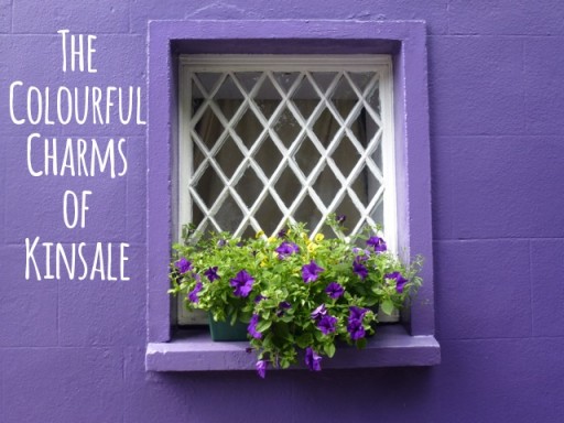 purple painted house with purple flowers on window sill