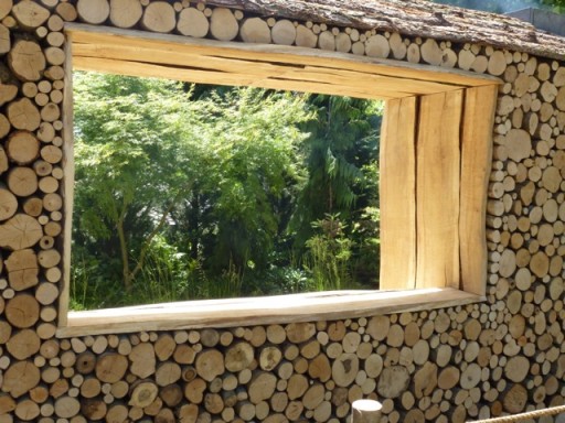 a large window breaks up a log wall