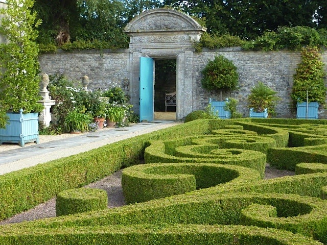 large wooden planters in formal garden