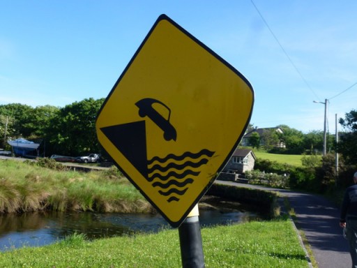 road sign showing car going into water