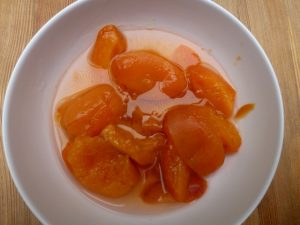 a bowl of apricots ready to eat